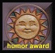 Humor award badge with a smiling carved sun face