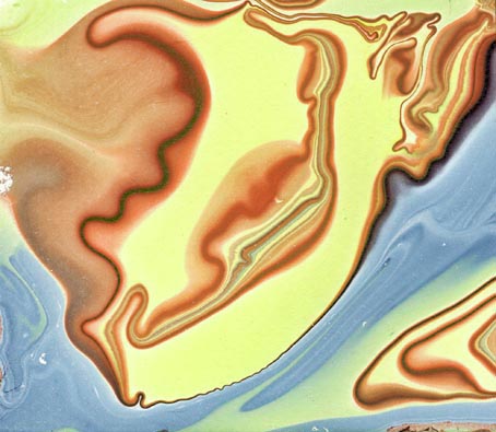Abstract swirling pattern of cream, brown and blue marbled shapes