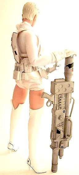 Action figure of a blonde woman in white armor seen from behind, holding a large rifle