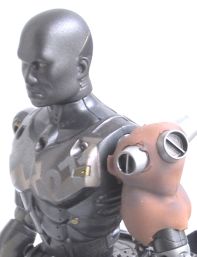 Model of a gray cyborg upper body with a small orange robot head on its shoulder